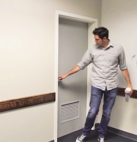 Image of man closing a door after spraying insecticide into a room