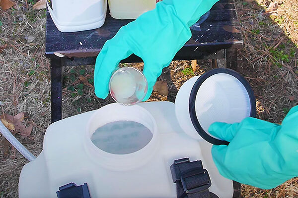 a photo of a plant growth regulator liquid being mixed into the tank of a sprayer